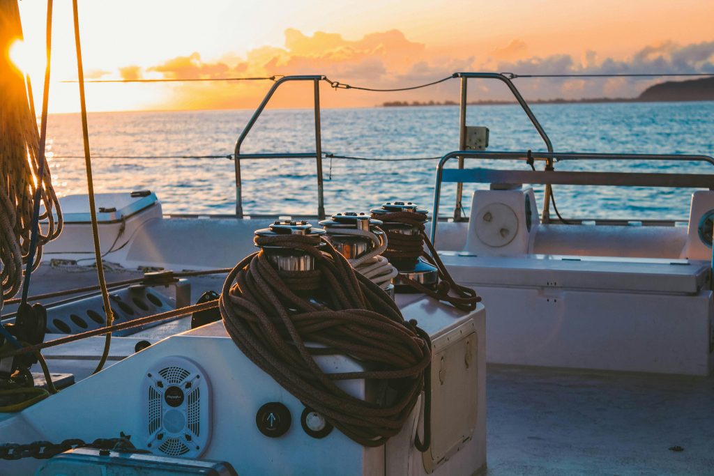 A serene view of a yacht deck during sunset in French Polynesia's Windward Islands.